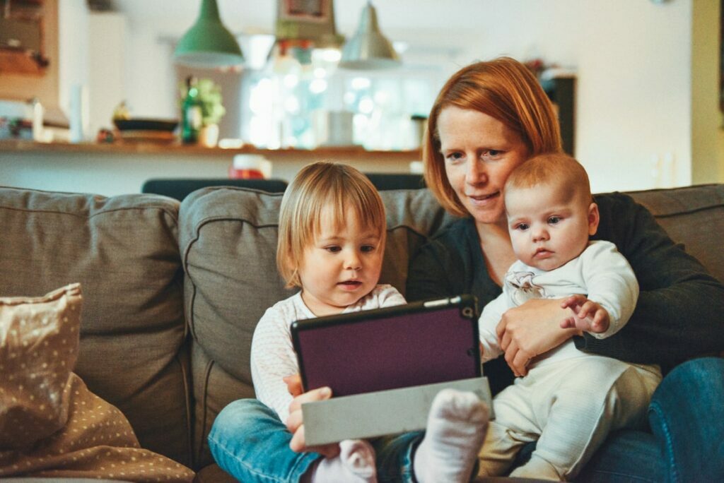 Mother with her two children looking at a tablet