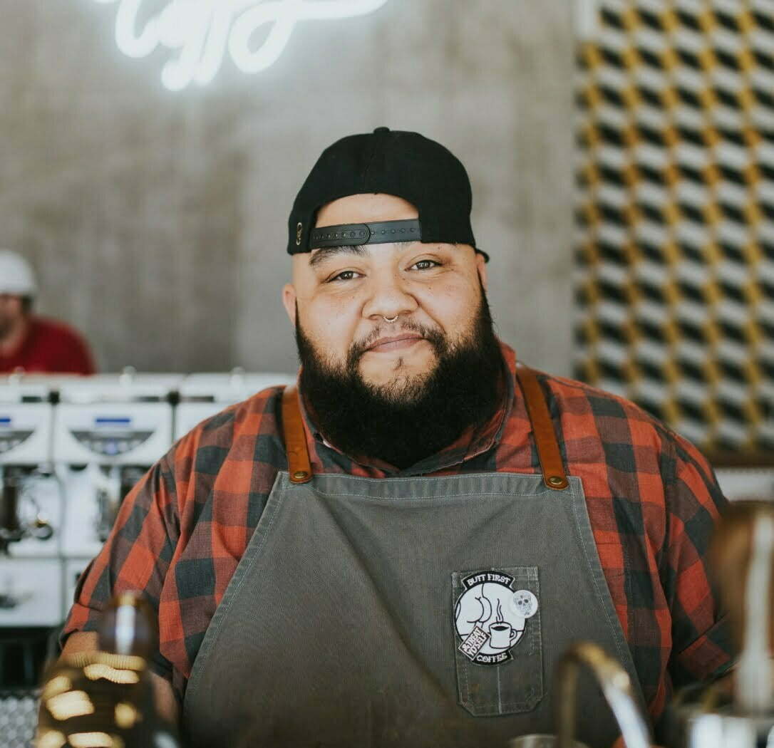 Barista standing behind the counter and smiling